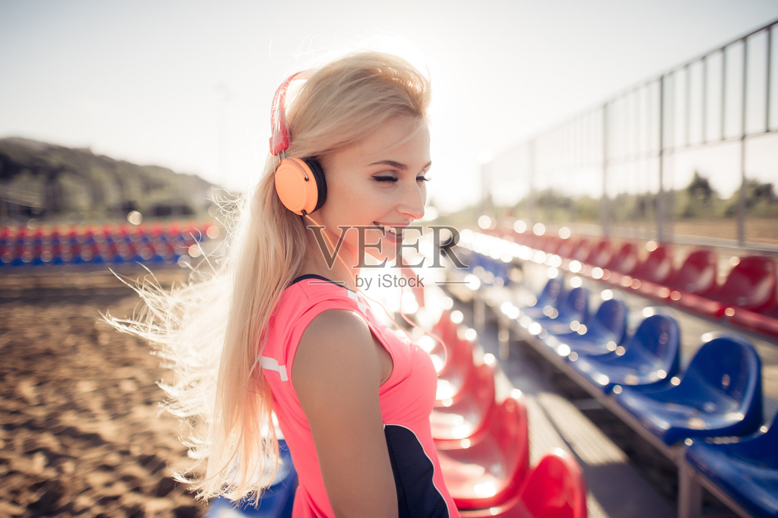 一个运动少女的肖像，在锻炼后休息，倾听照片摄影图片