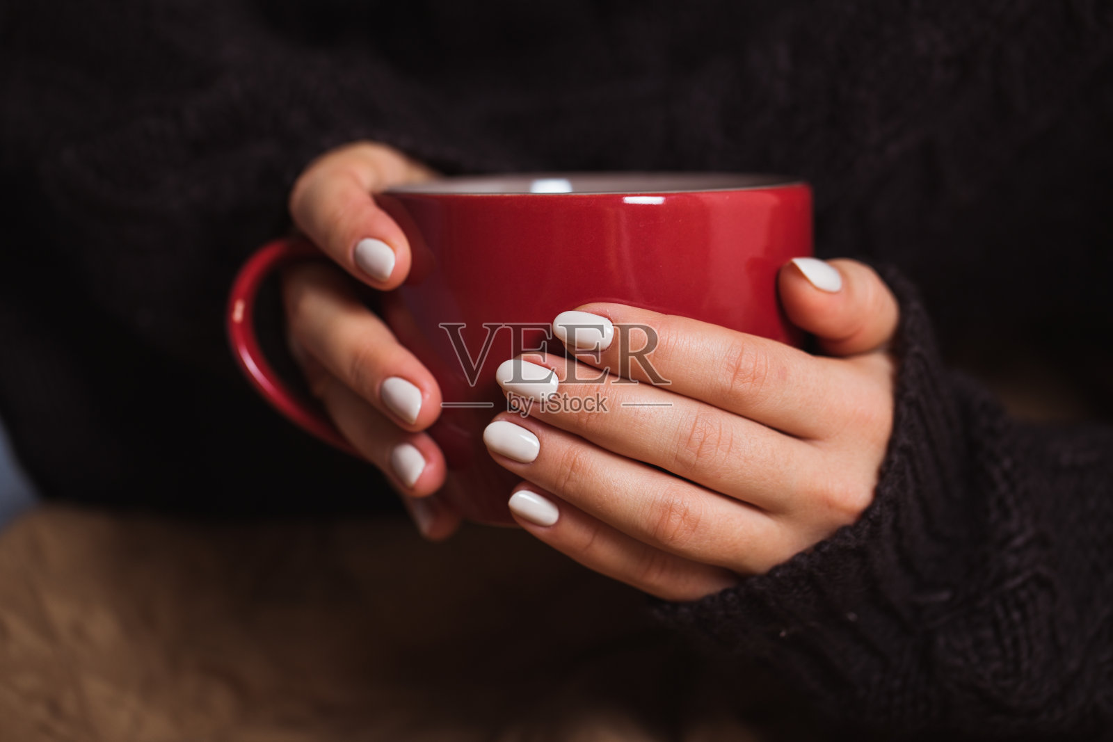 有漂亮美甲的女人拿着一杯红茶照片摄影图片