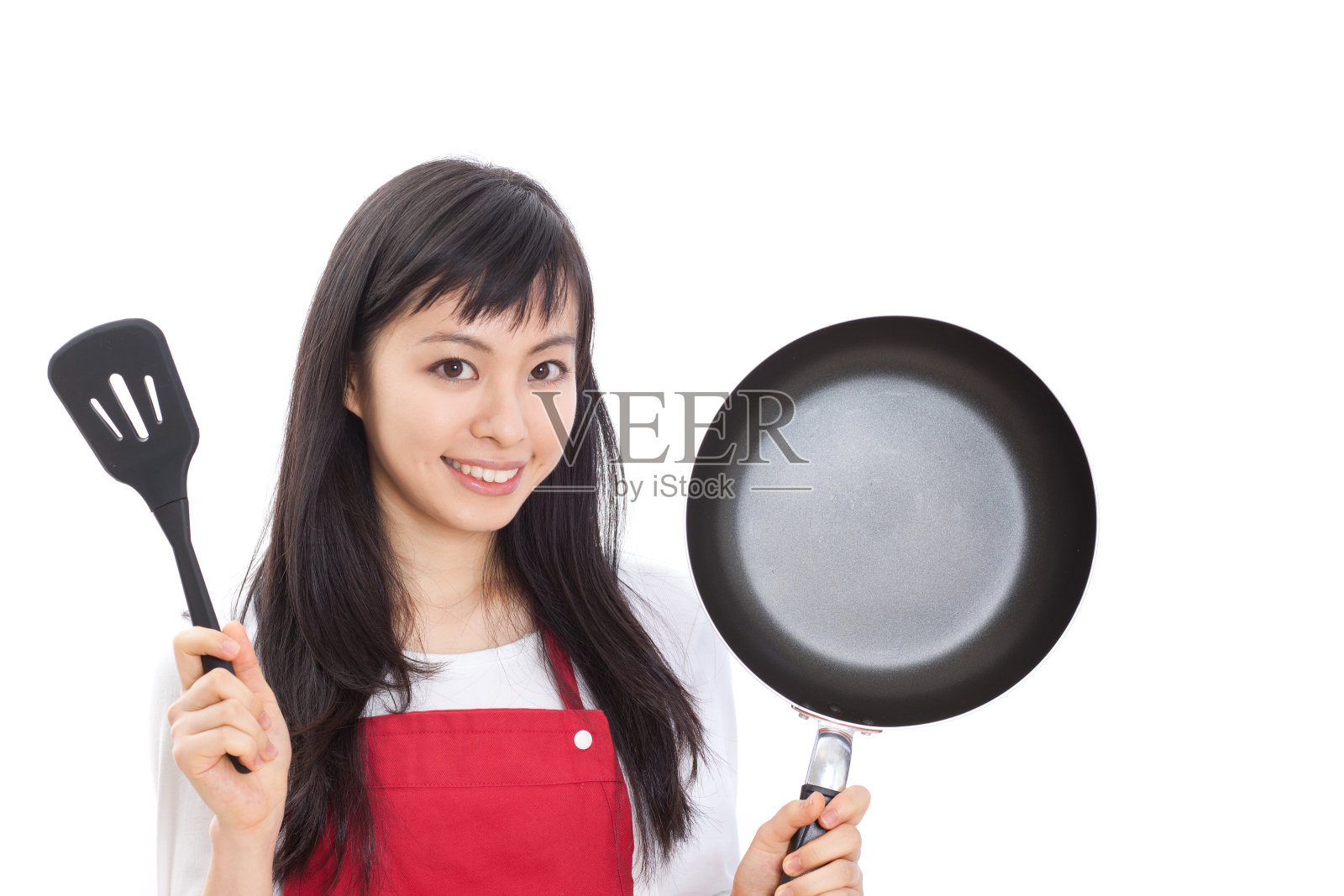 一个拿着平底锅和抹刀的日本女人照片摄影图片