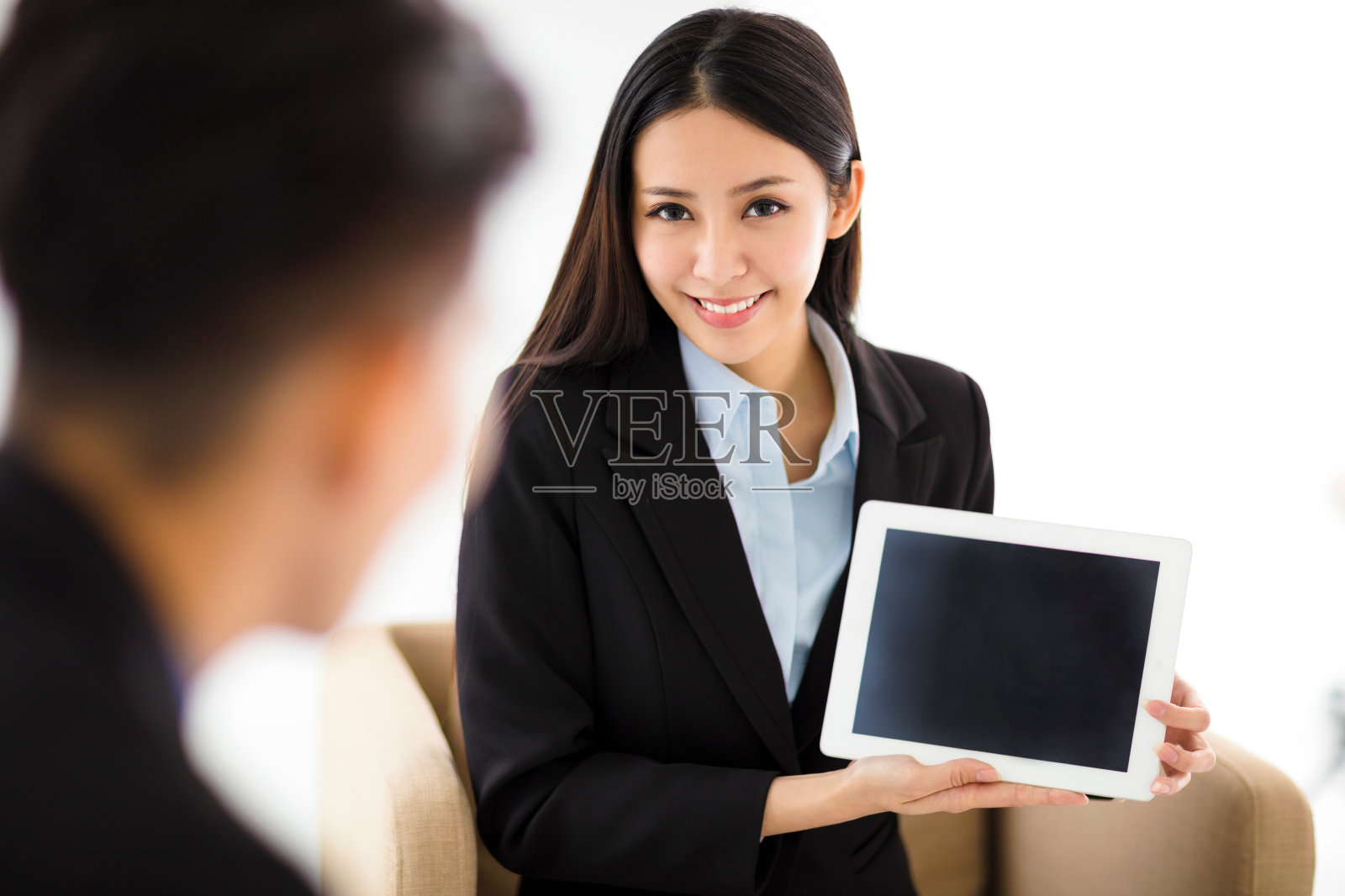 年轻的女商人在办公室里展示空白的写字板照片摄影图片