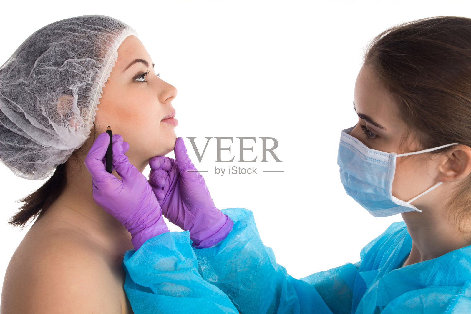 医生正在画一张脸照片摄影图片