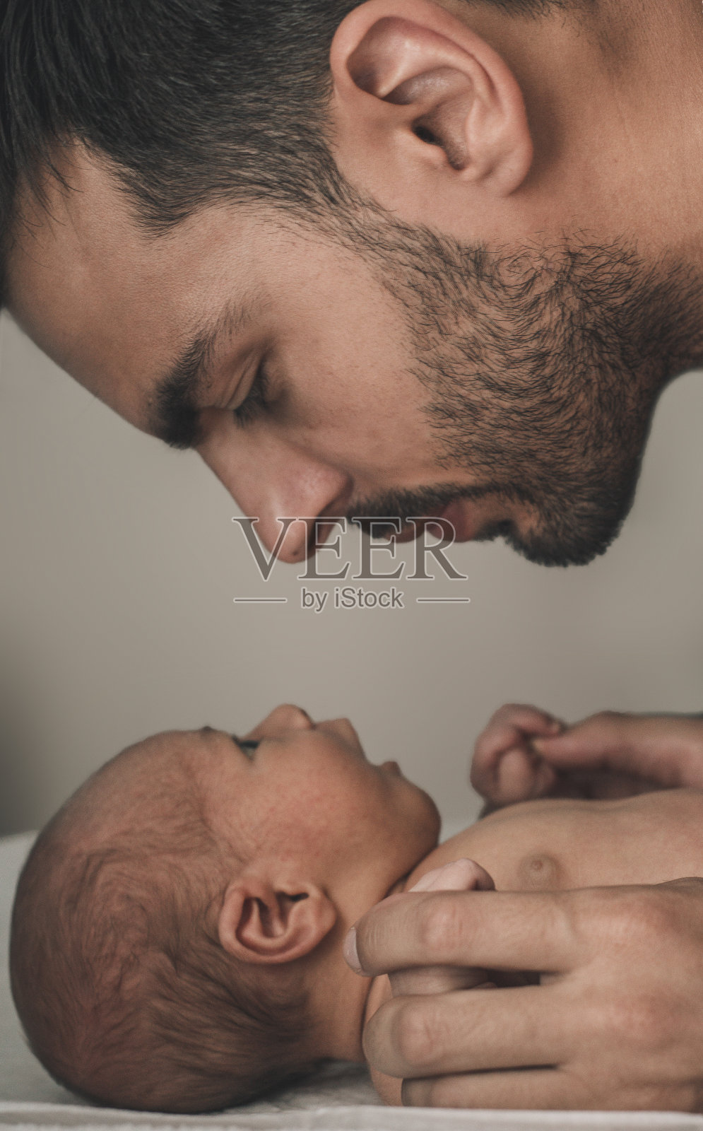 慈爱的父亲和孩子在家里的肖像。深褐色的照片摄影图片