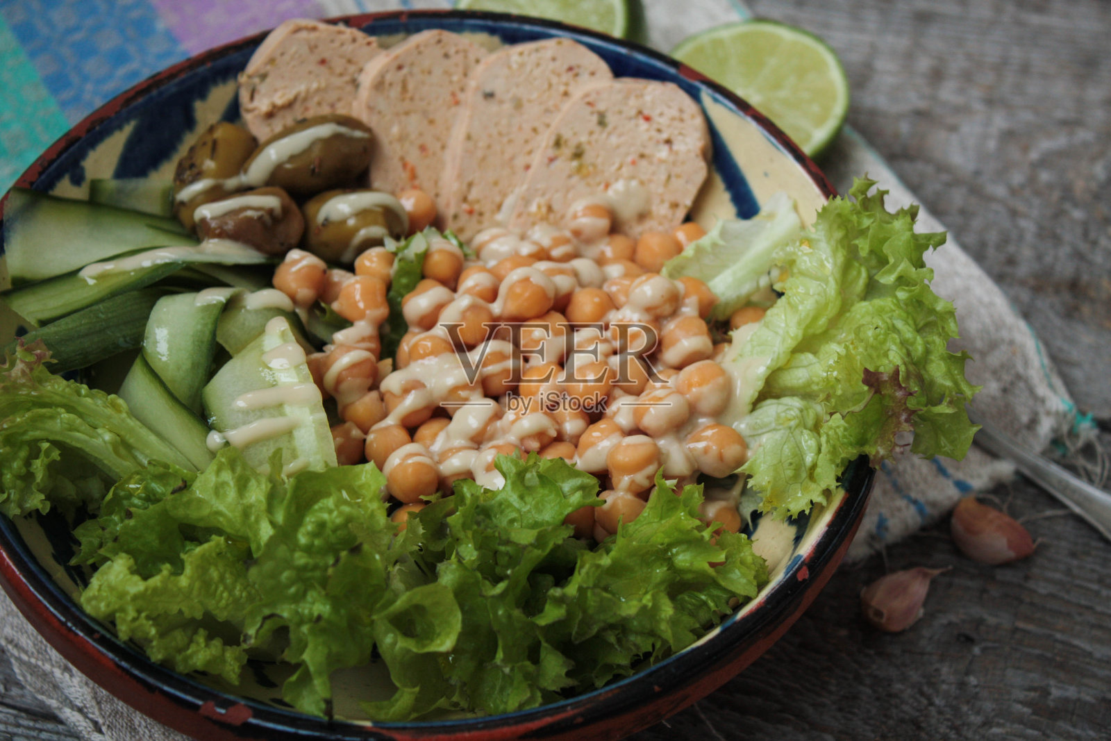 一碗健康沙拉。橄榄，酸橙，鹰嘴豆，辣椒豆腐，照片摄影图片