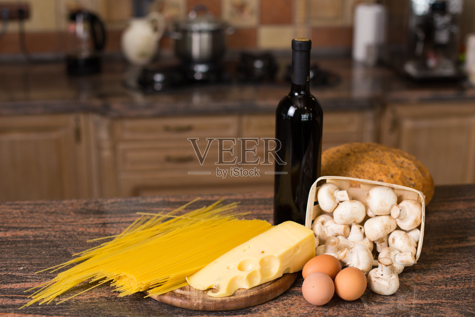 意大利面，鸡蛋，奶酪，蘑菇，面包和一瓶酒照片摄影图片