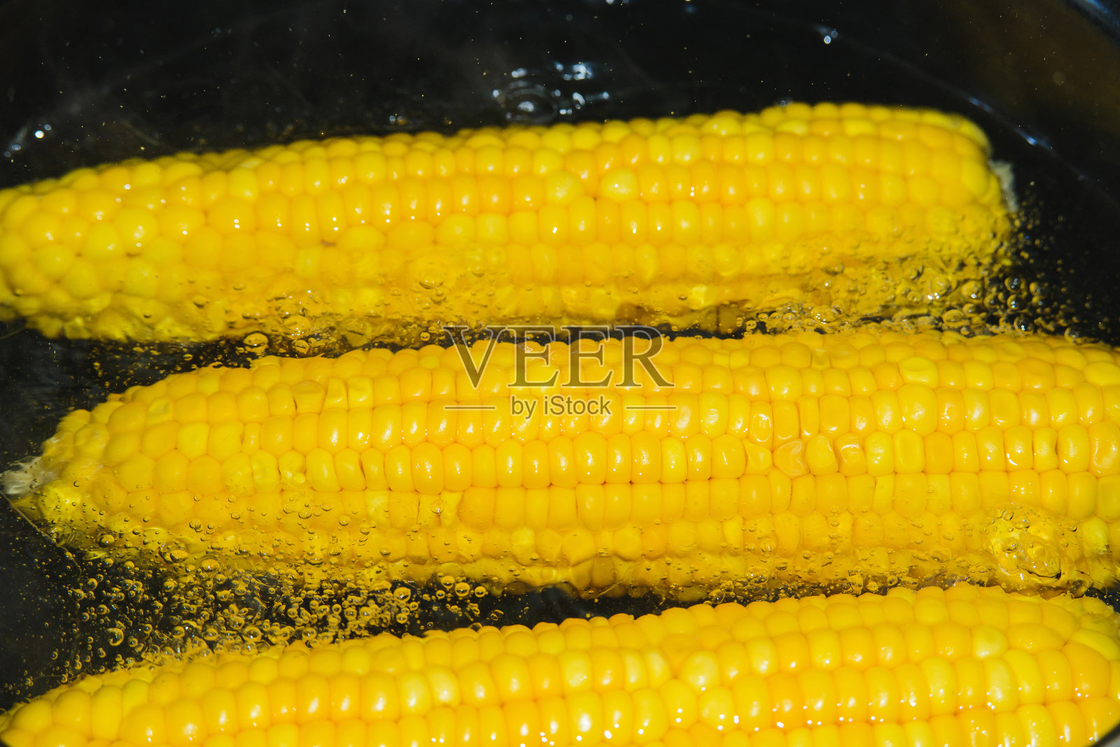 在厨房用平底锅煮玉米照片摄影图片
