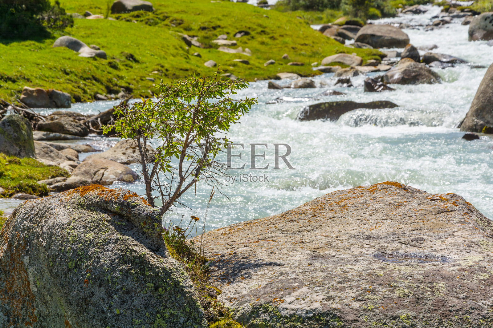 一段山河带着一块巨大的石头。照片摄影图片