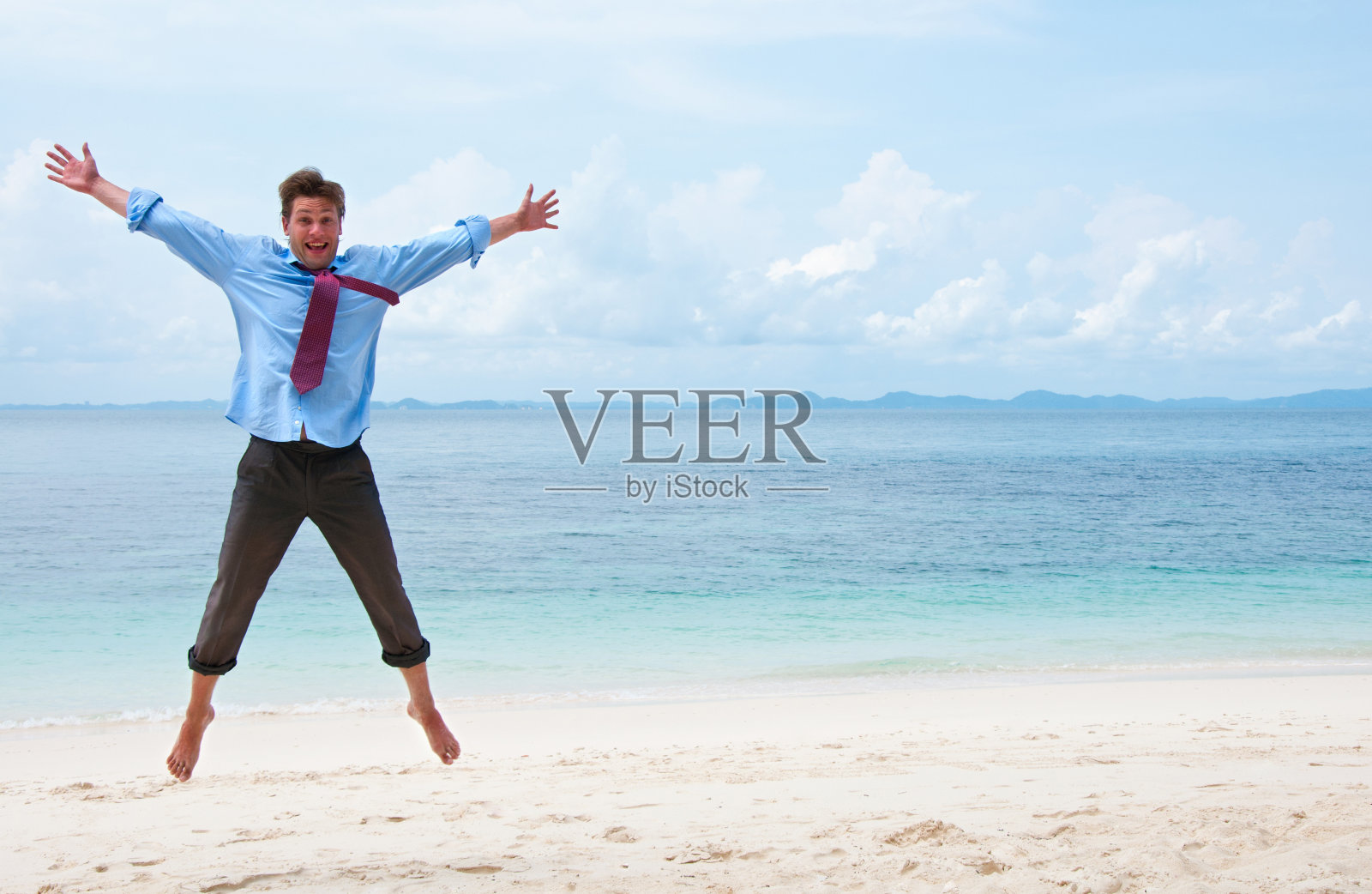 有趣的商人在海滩上跳照片摄影图片