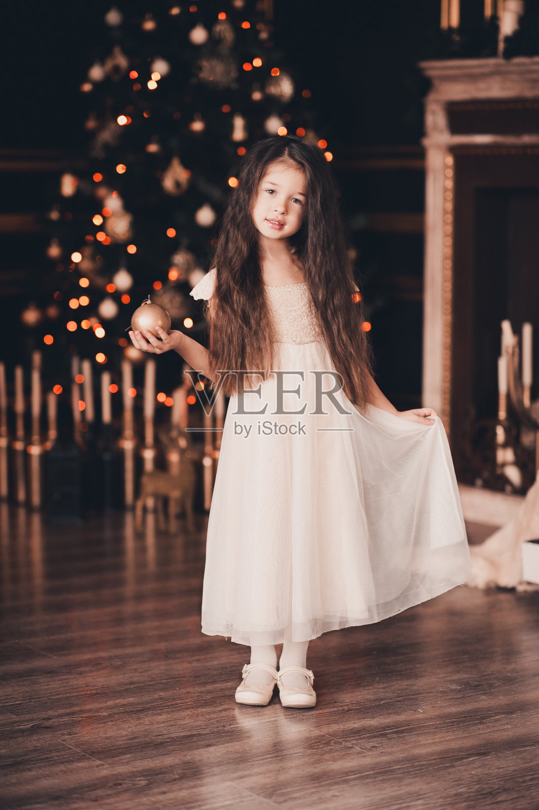 漂亮的小女孩装饰圣诞树照片摄影图片