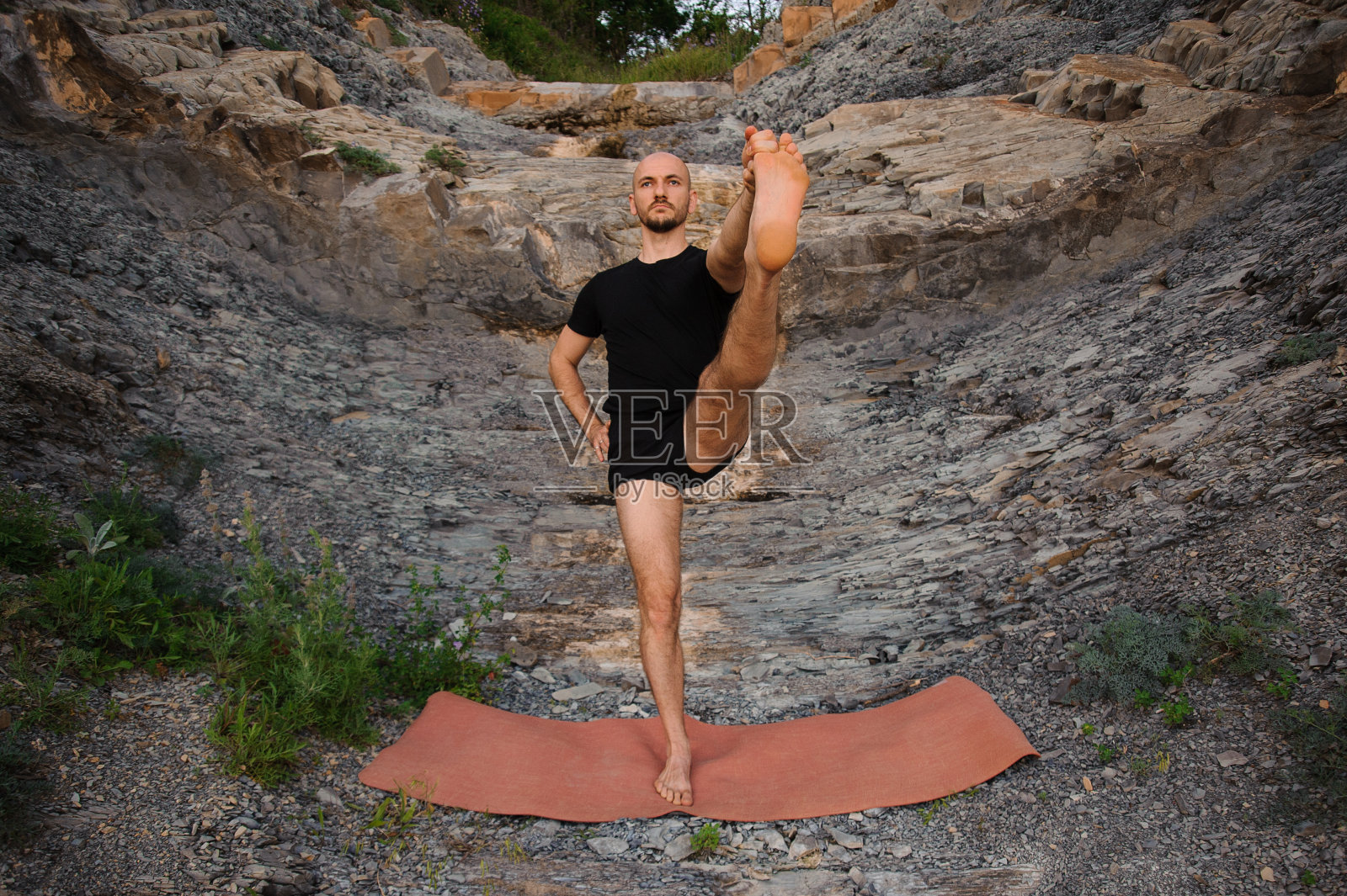 一个人在户外的岩石上做瑜伽照片摄影图片