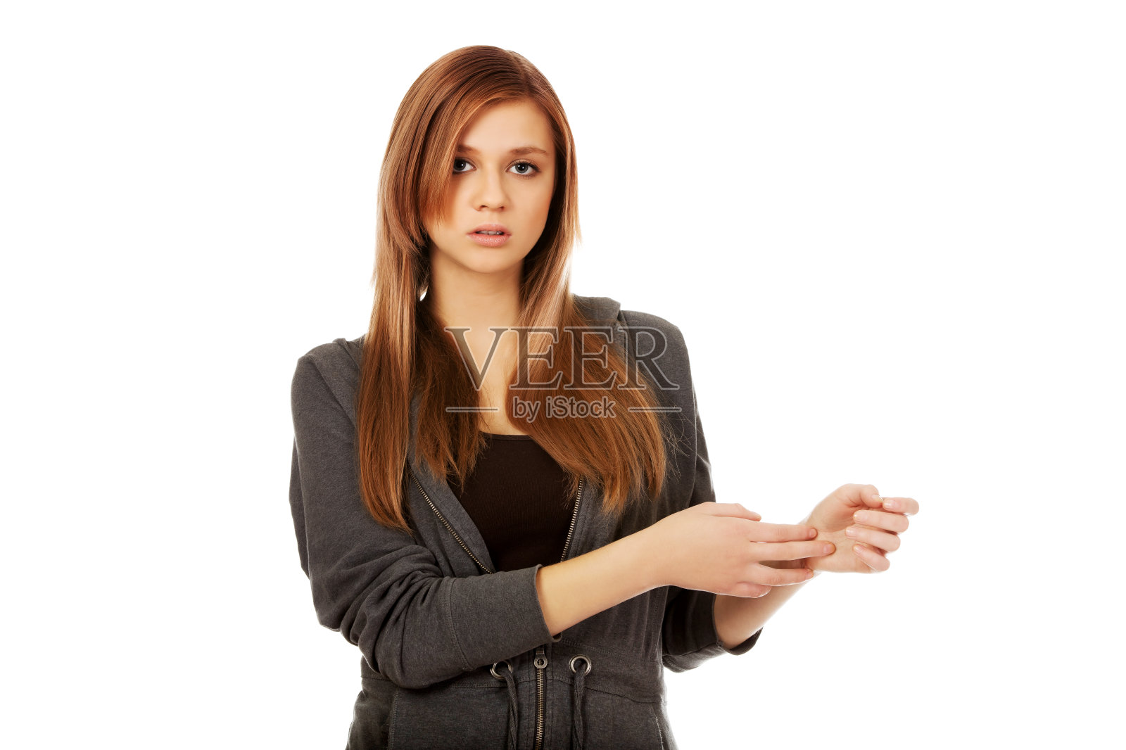 十几岁的女人抱着她的手腕疼痛的概念照片摄影图片