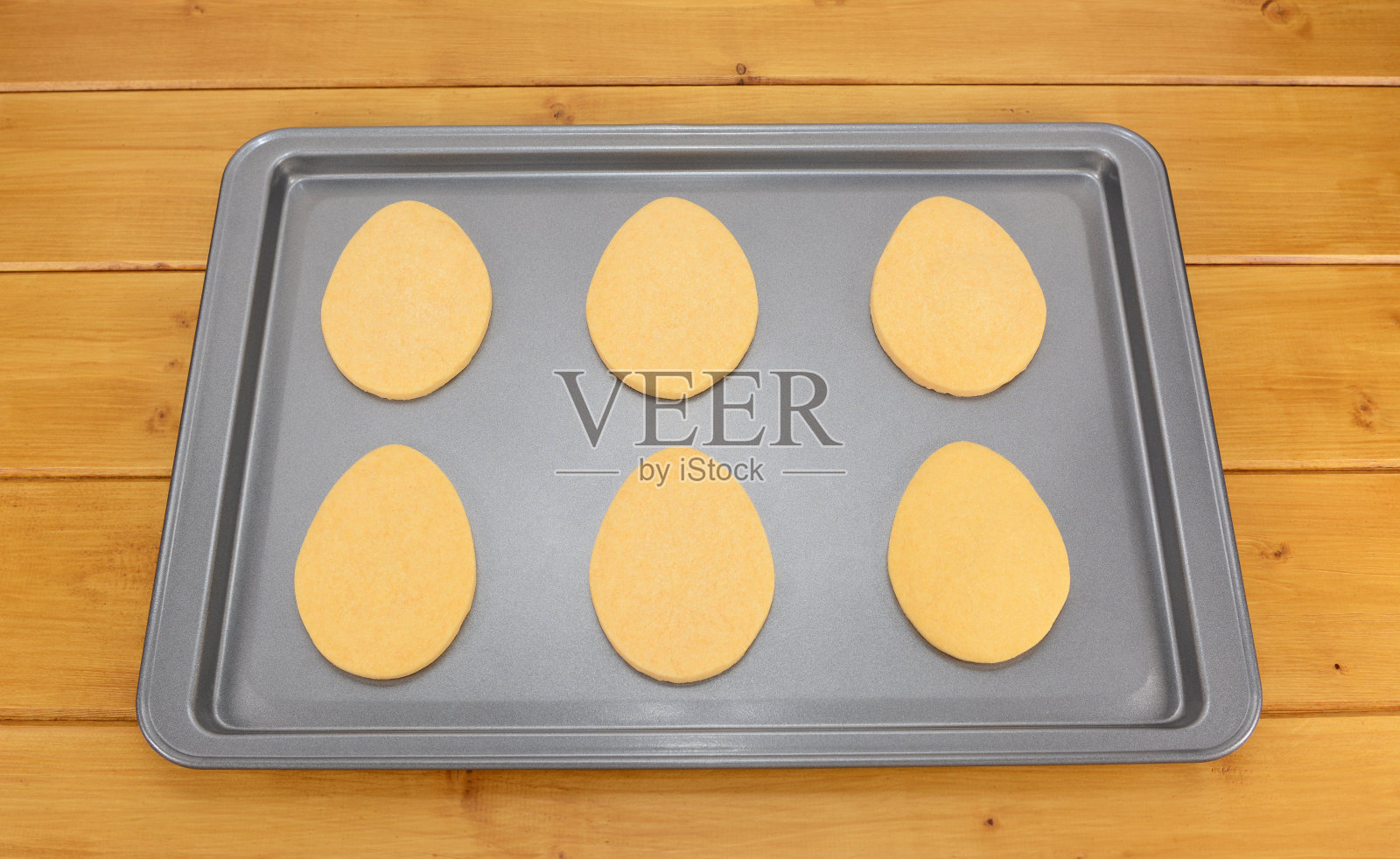 烤盘上放着六块蛋形复活节饼干照片摄影图片