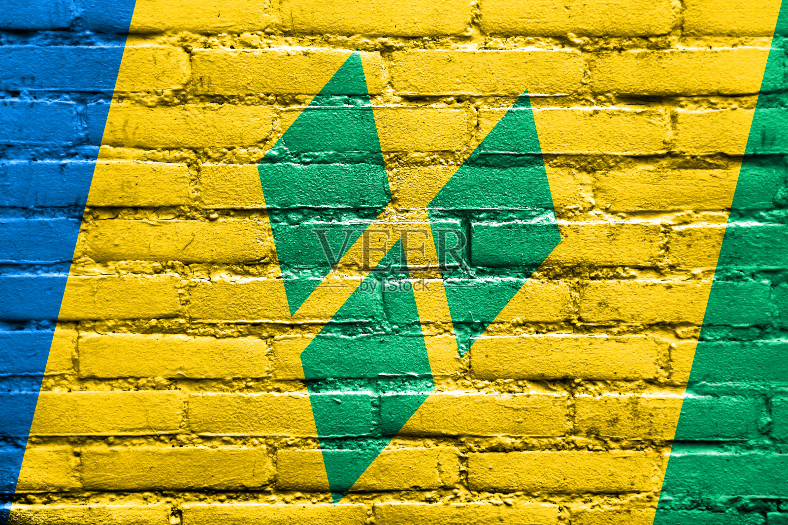 圣文森特和格林纳丁斯的旗帜画在砖墙上照片摄影图片