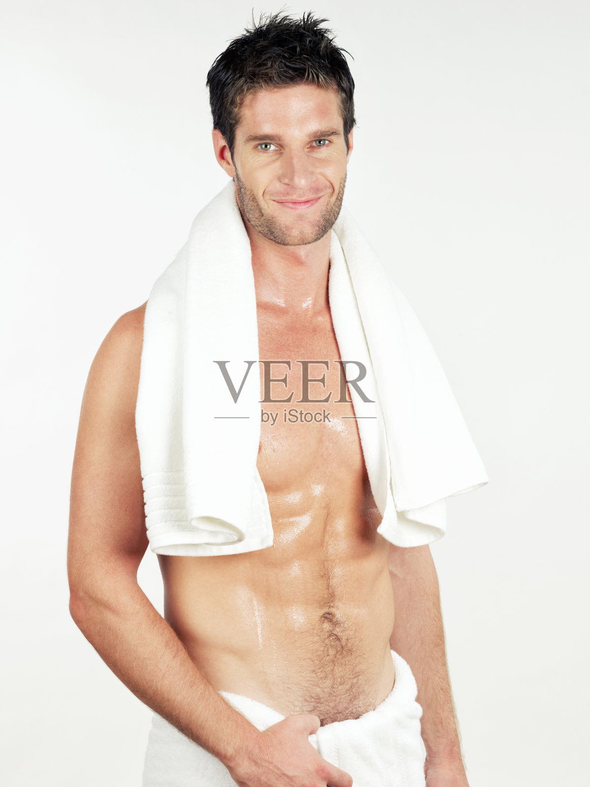 男人裹着浴巾，手放在臀部微笑照片摄影图片