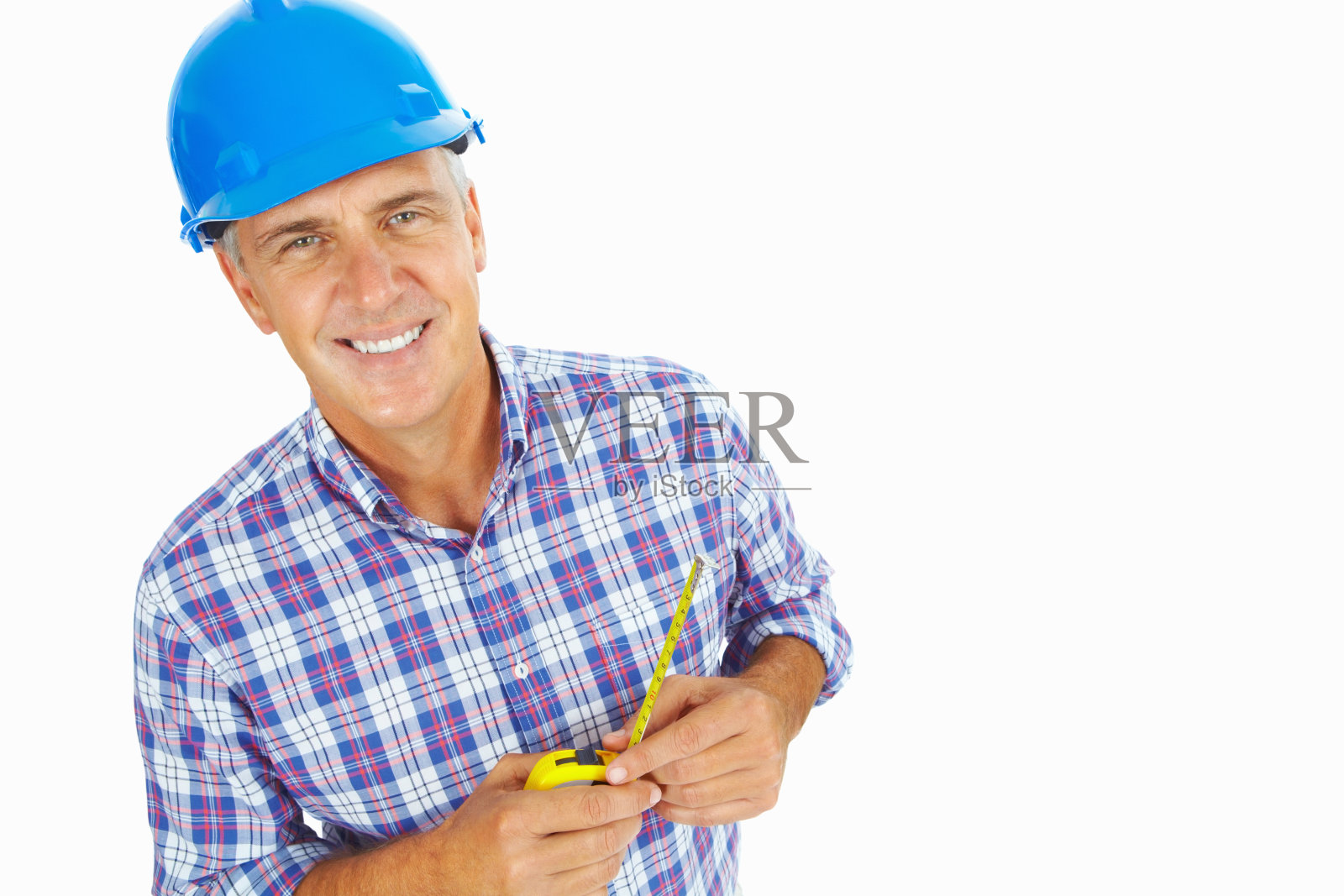 一个戴着安全帽拿着卷尺的男人的肖像照片摄影图片