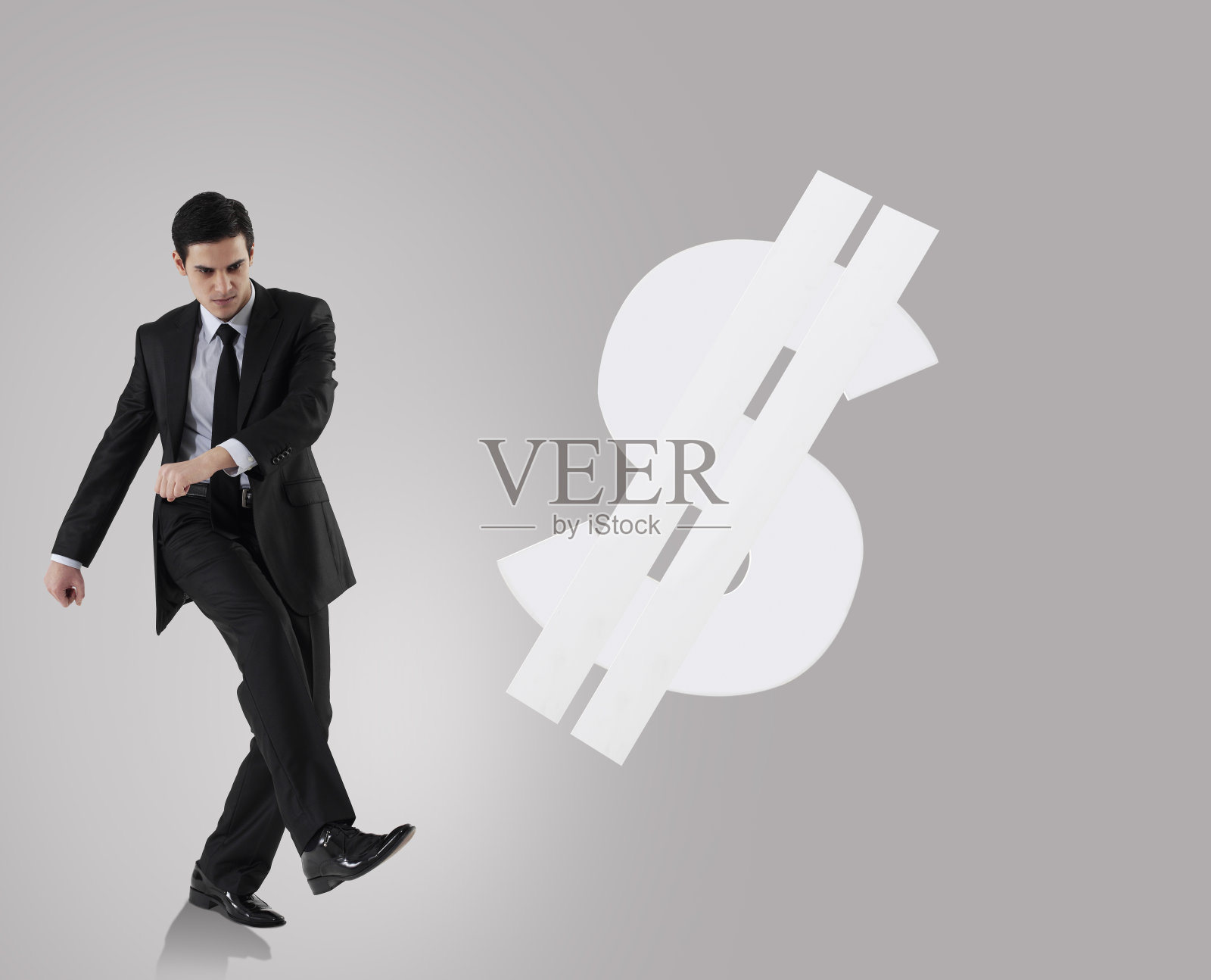 商人踢美元符号照片摄影图片