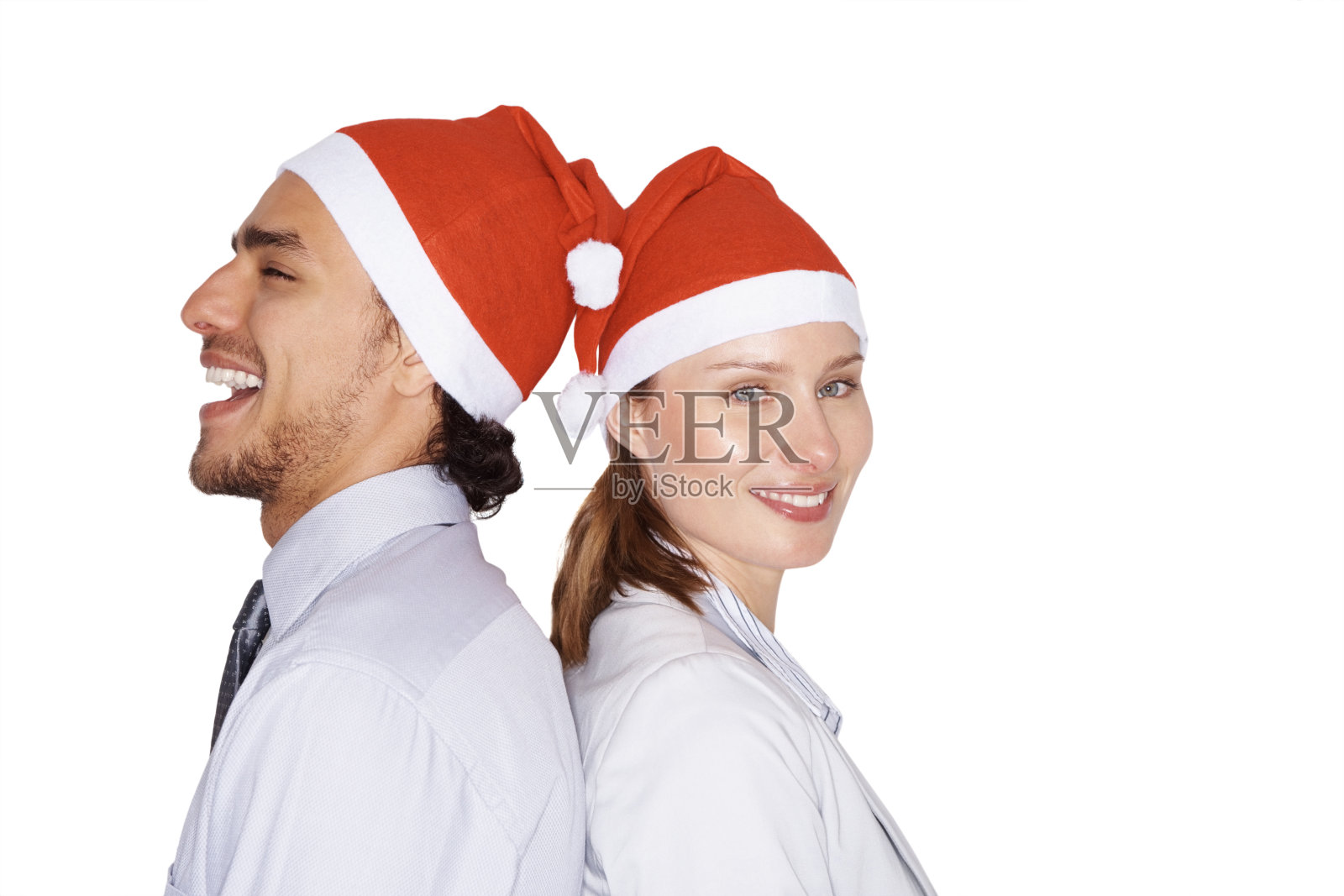 同事们戴着圣诞老人帽站在一起照片摄影图片