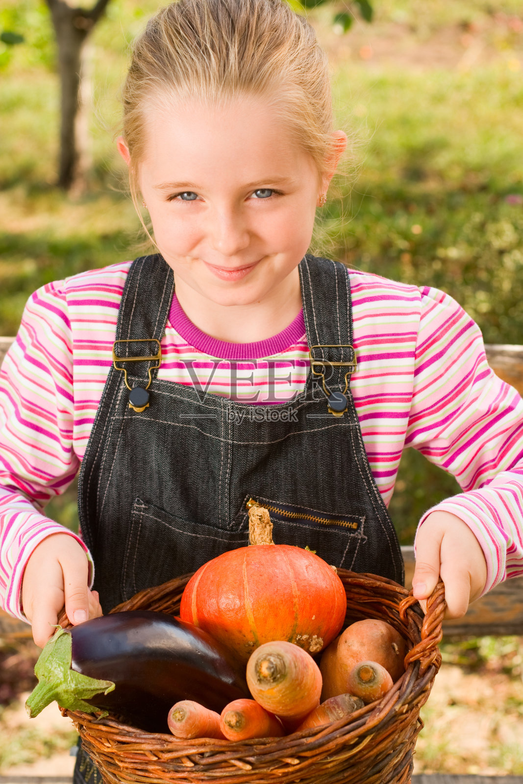 拿着满满一篮子蔬菜的女孩照片摄影图片