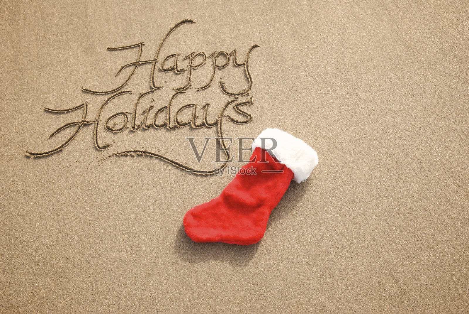 沙袜子上书法的节日问候短信照片摄影图片