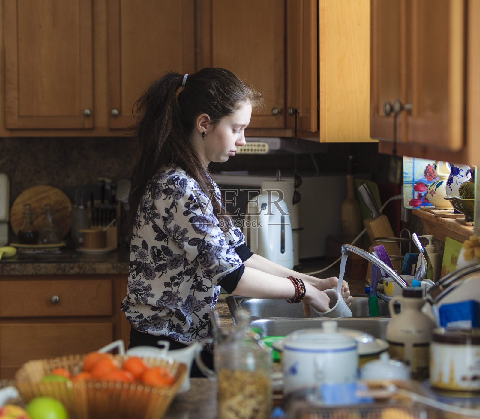 终日忙着洗盘子和盘子的少女照片摄影图片