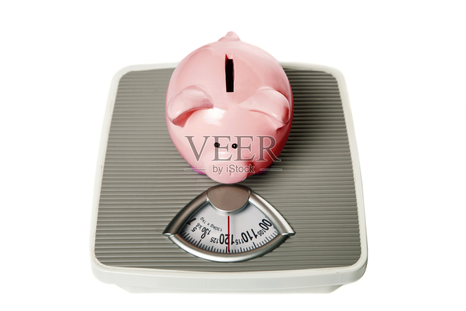 存钱罐坐在秤上照片摄影图片