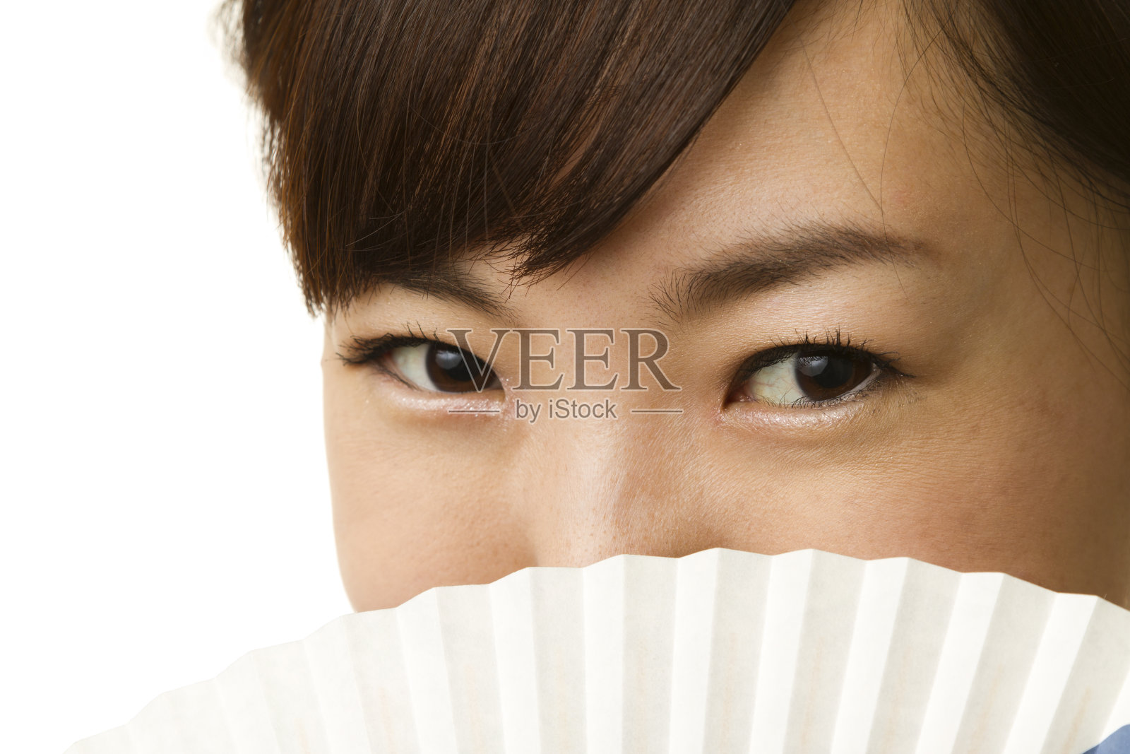 特写的日本妇女覆盖她的脸与纸扇照片摄影图片