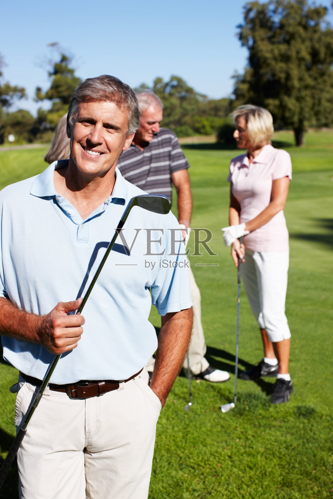 拿着高尔夫球杆的快乐男人照片摄影图片