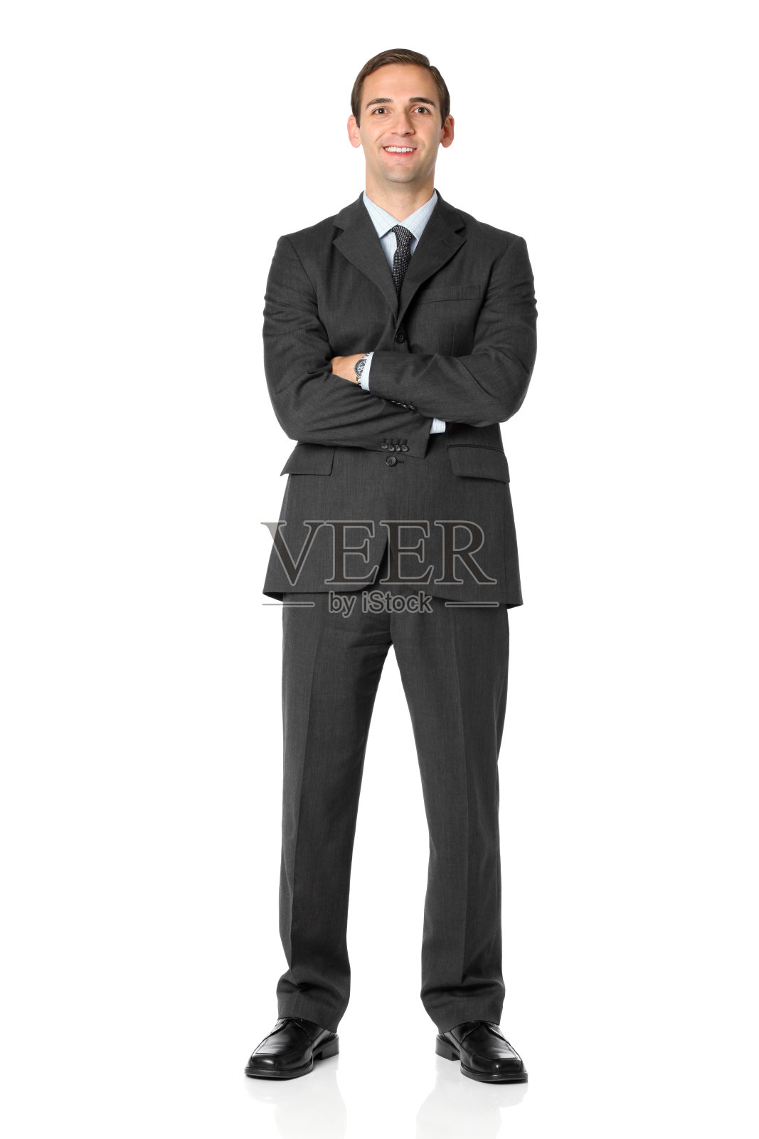 双臂交叉站着的商人照片摄影图片