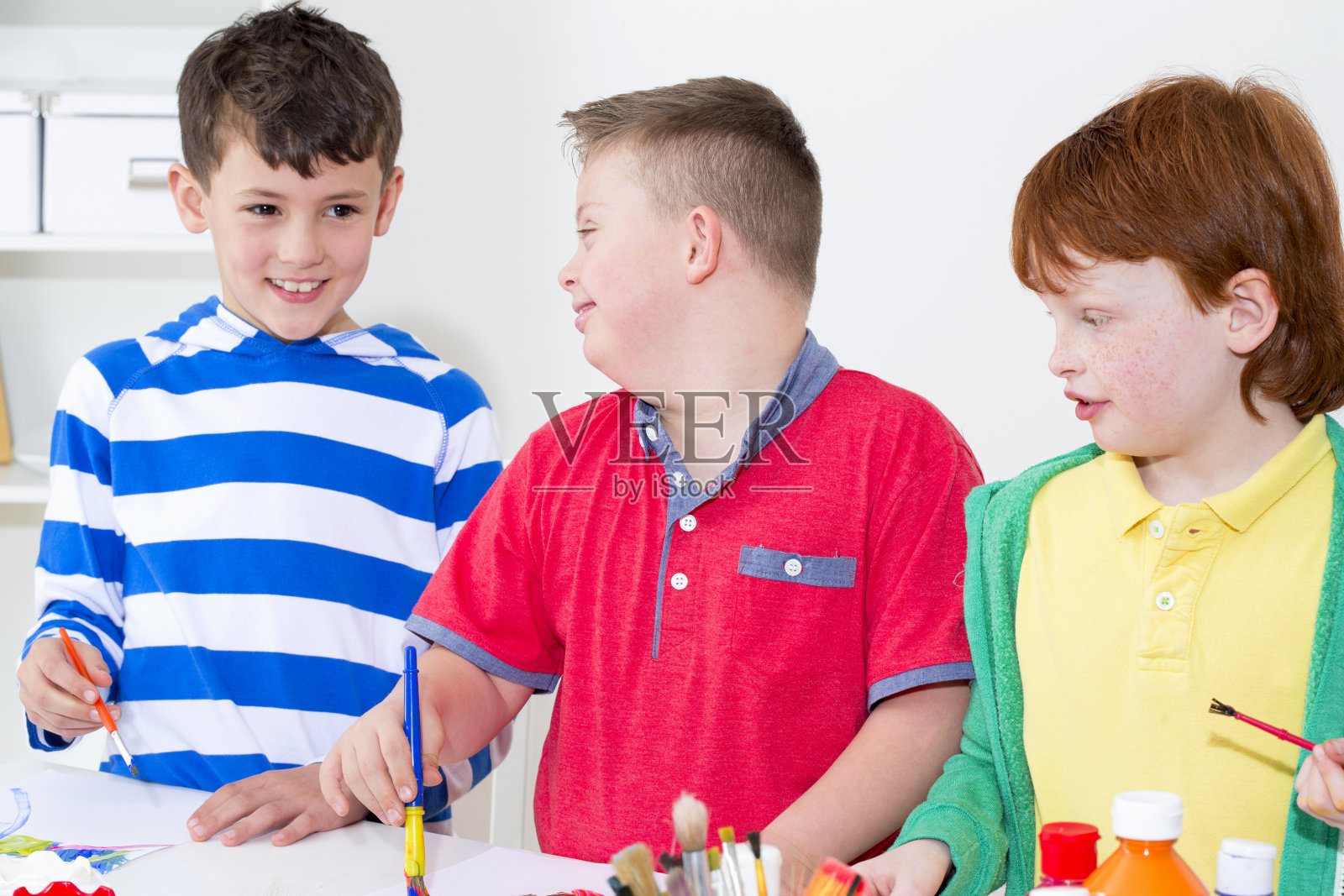 患有唐氏综合征的男孩和朋友们一起绘画照片摄影图片