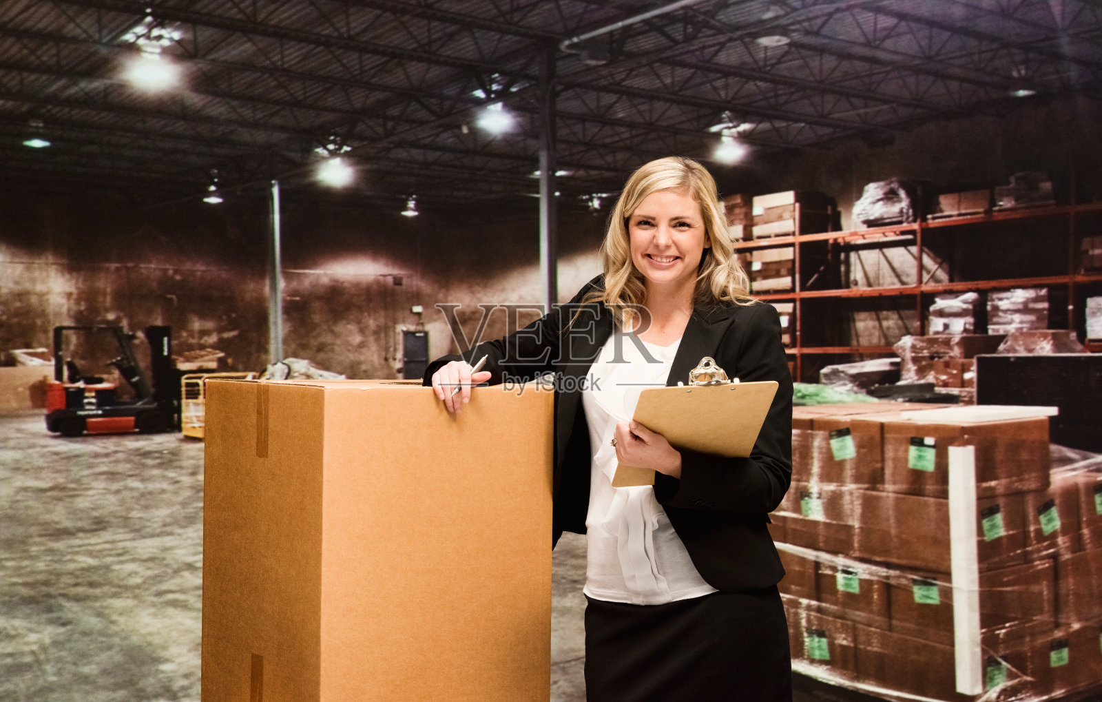 女商人站在仓库里照片摄影图片