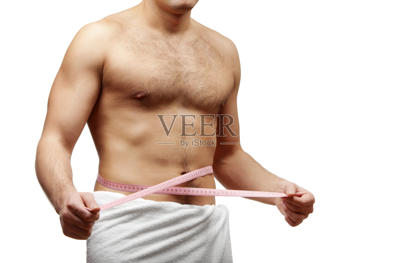 男性美。正在测量腰围的年轻人照片摄影图片