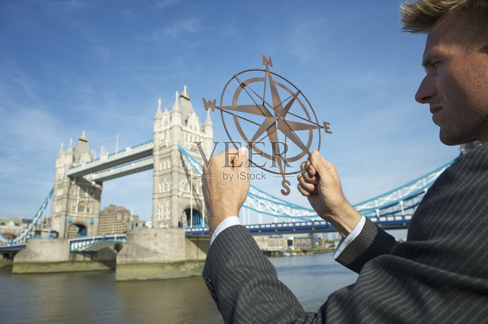 商人在伦敦地平线上手持指南针照片摄影图片