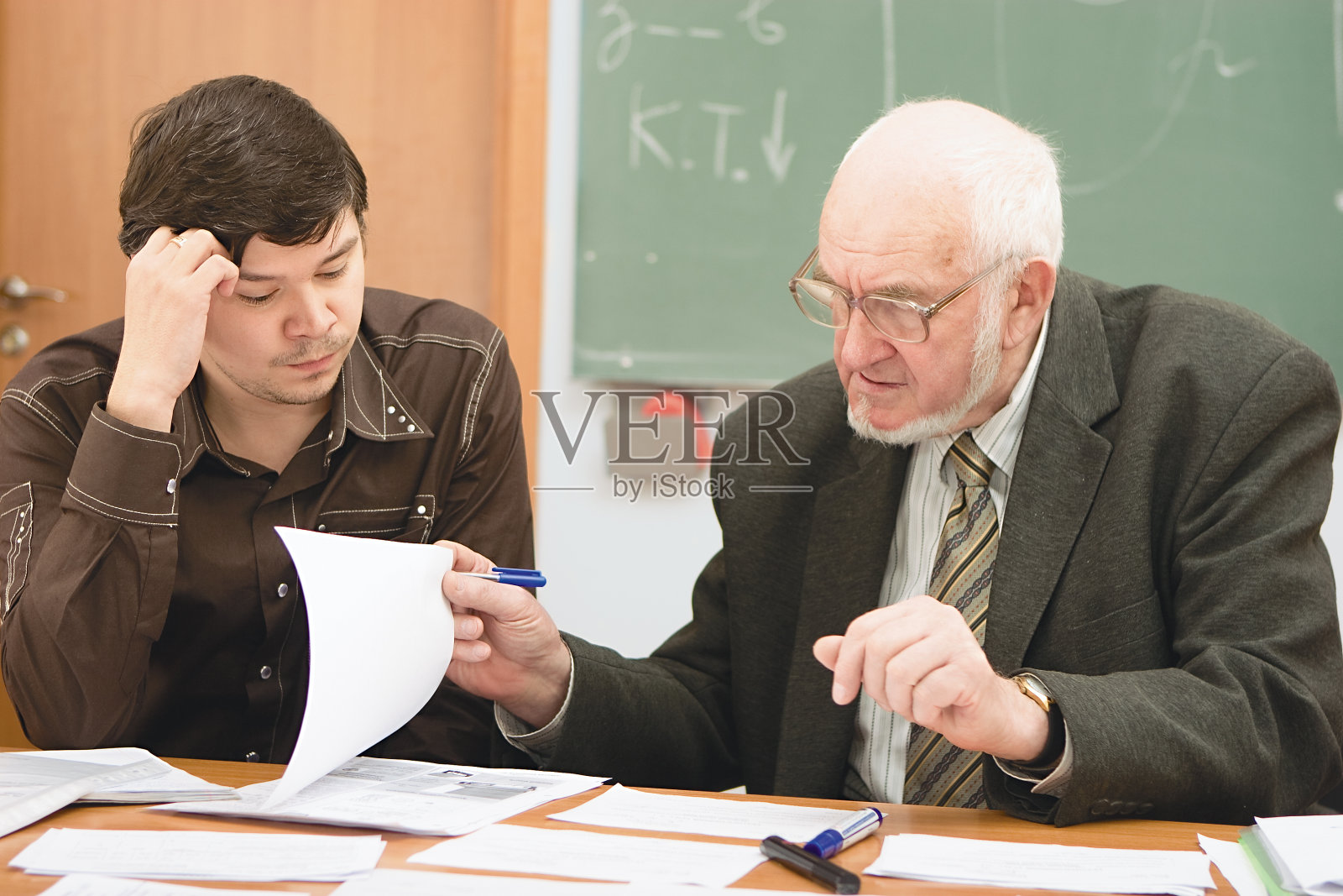 高级教授审查学生的项目照片摄影图片
