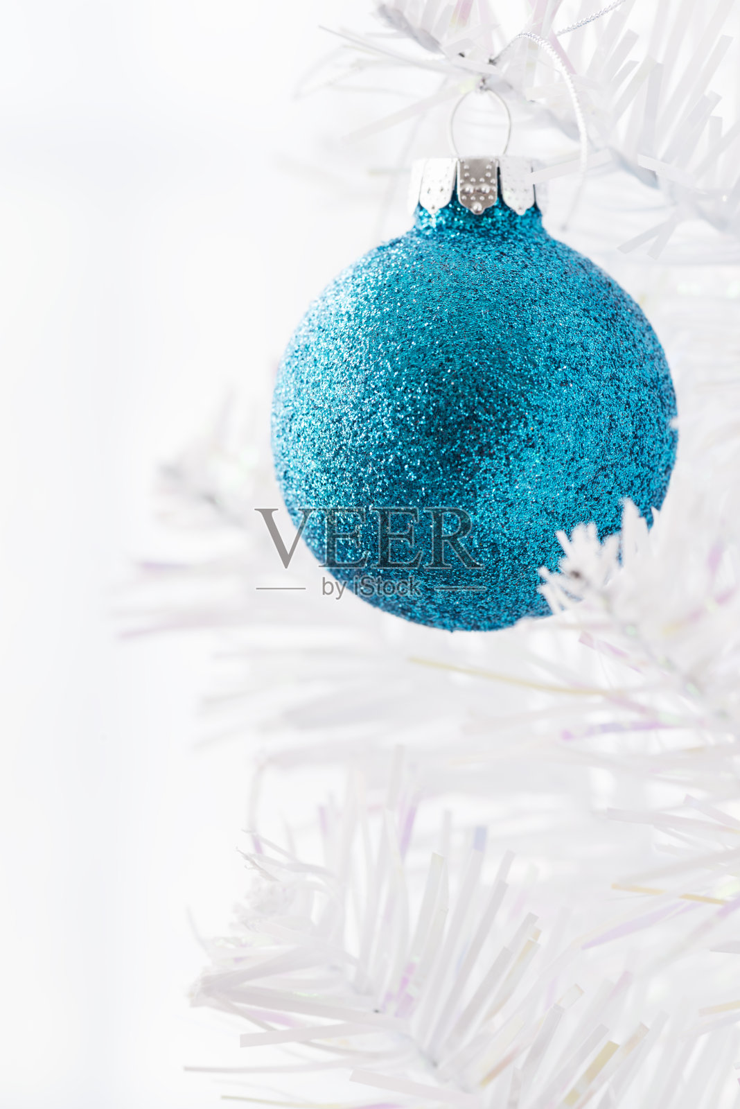 蓝色的闪耀圣诞球在一个白色的树垂直照片摄影图片