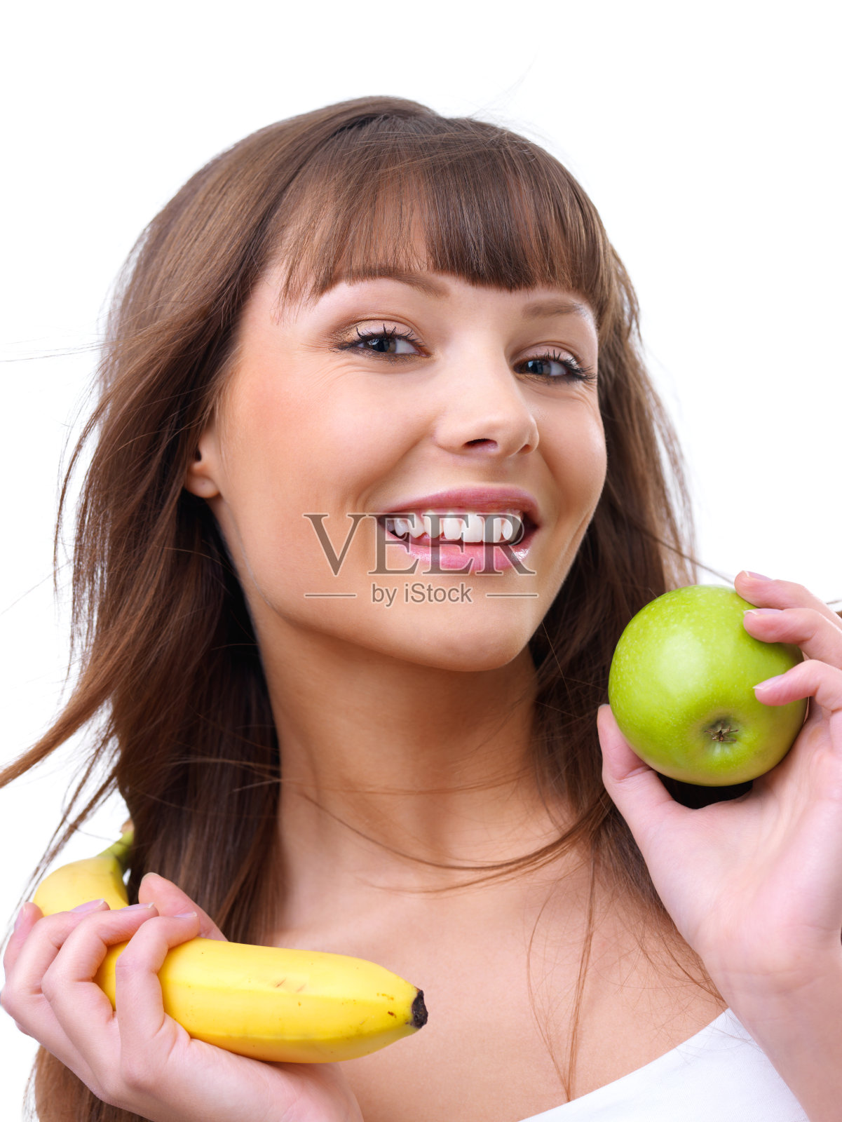 年轻女子拿着青苹果和香蕉照片摄影图片