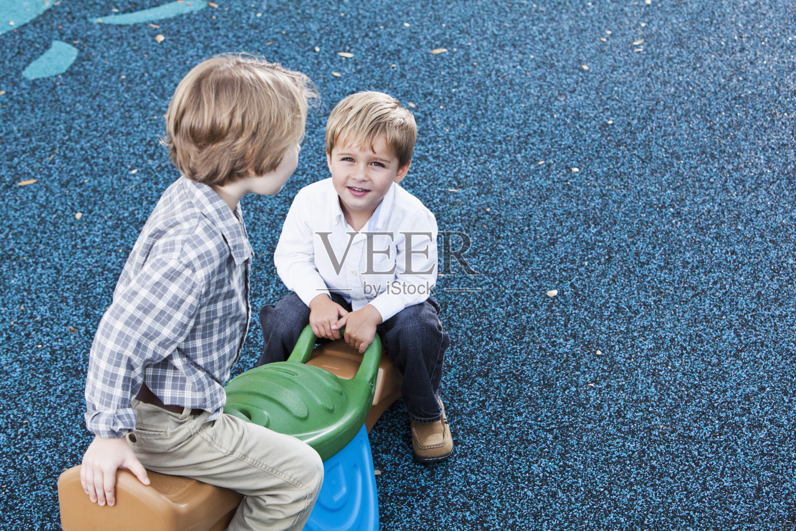 小男孩在跷跷板上摇摆照片摄影图片