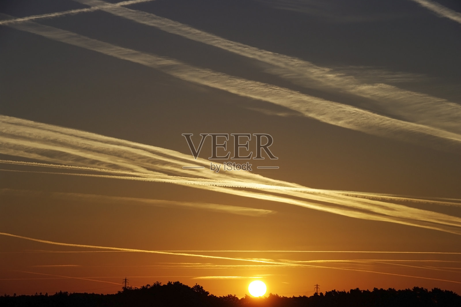 日出的天空布满了尾迹照片摄影图片