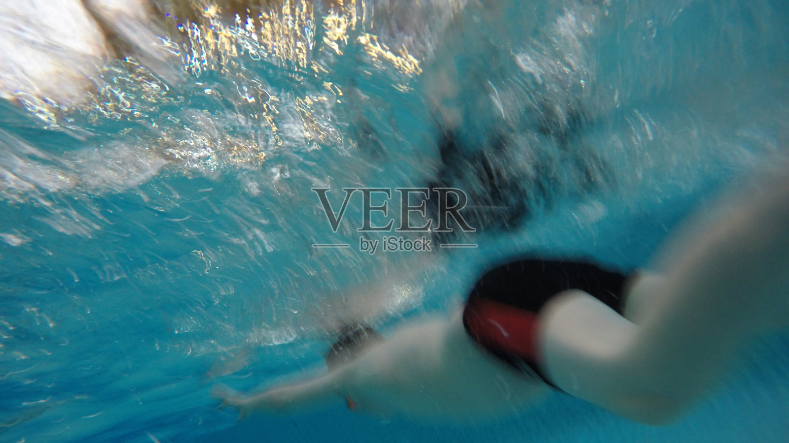 一个男孩在游泳池的水下照片摄影图片