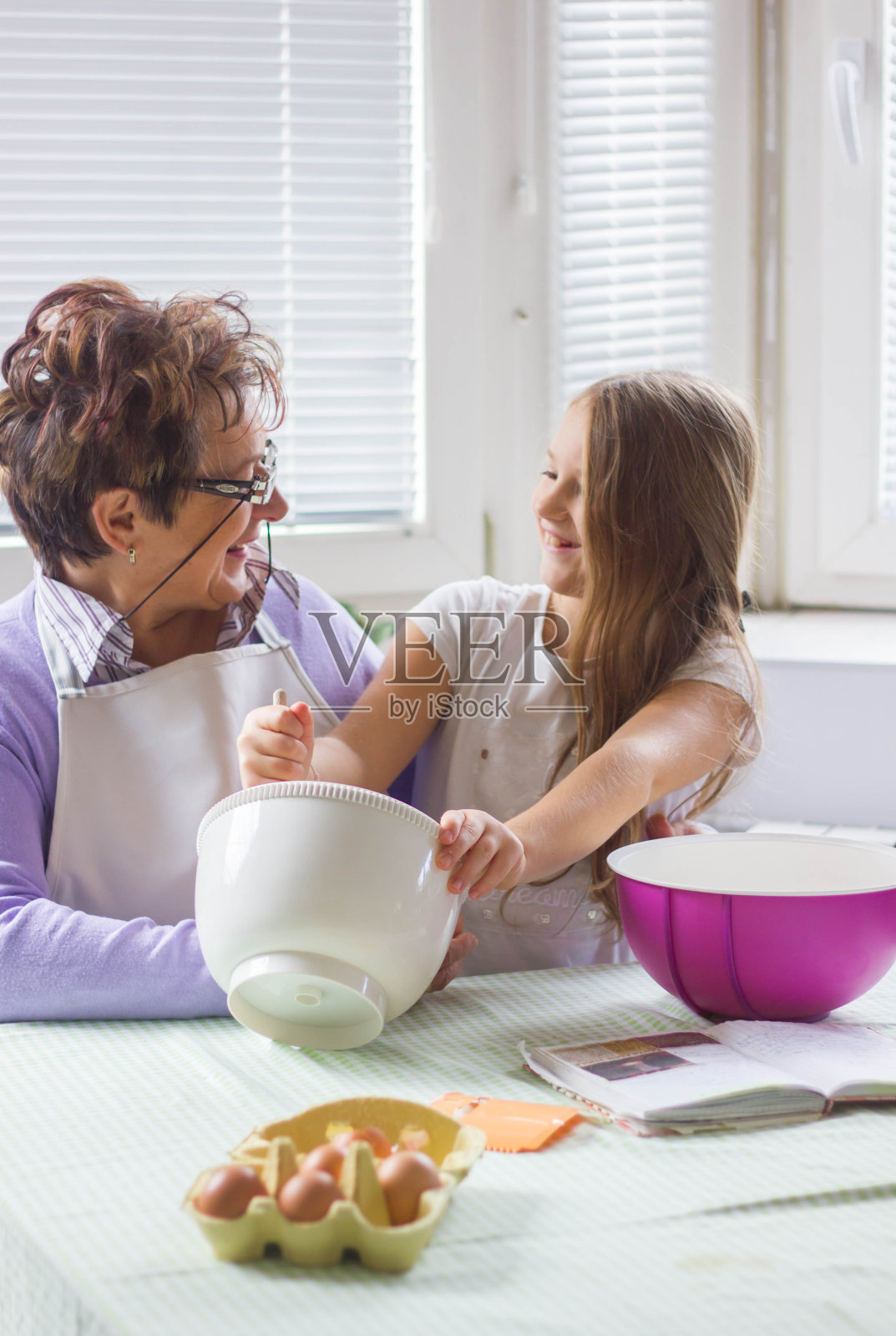 奶奶和孙女在做饼干。照片摄影图片