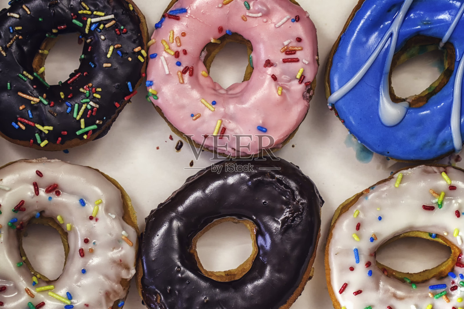 美味的甜甜圈和彩色糖衣照片摄影图片