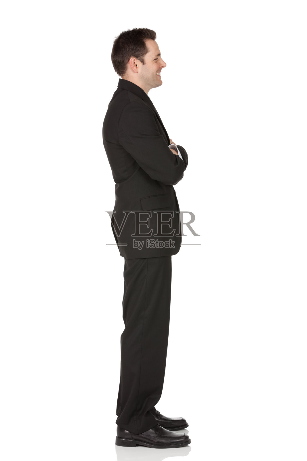 双臂交叉站着的商人照片摄影图片