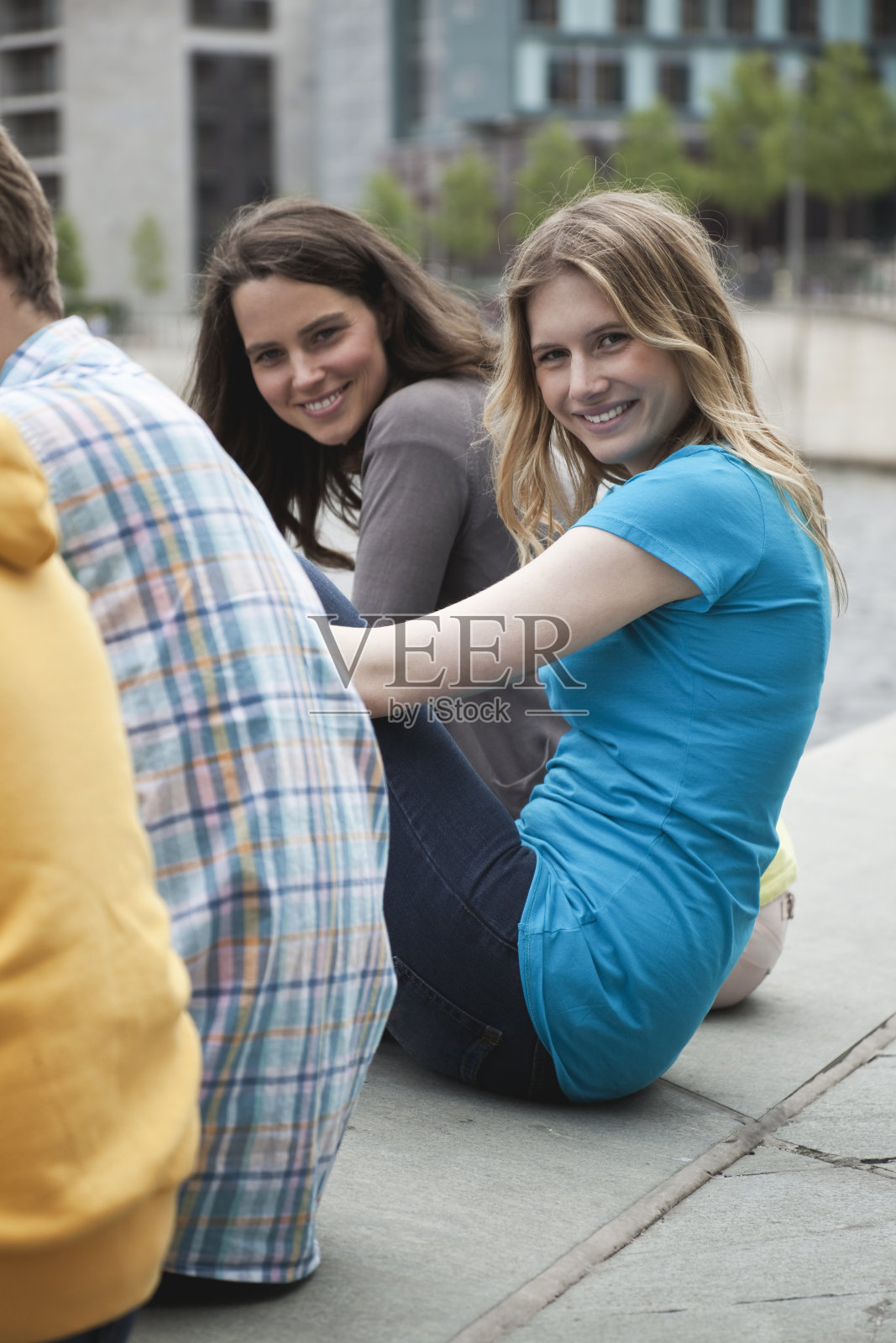 德国，柏林，女人微笑着坐着，中间的男人照片摄影图片