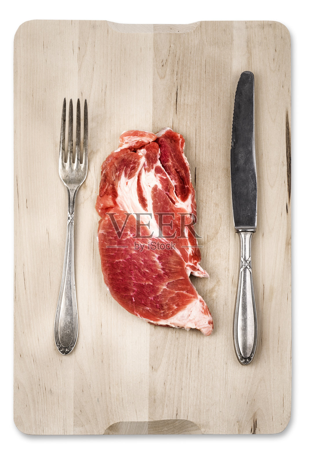 生肉块放在木头上，用刀叉照片摄影图片