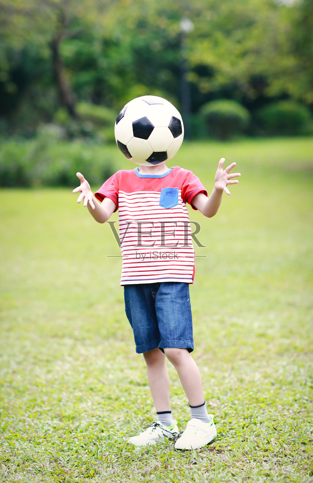 拿着足球的男孩照片摄影图片