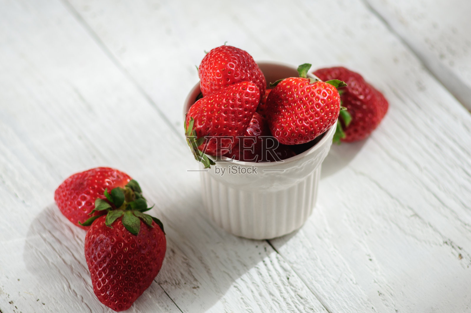 瓷杯草莓，白色木质背景照片摄影图片