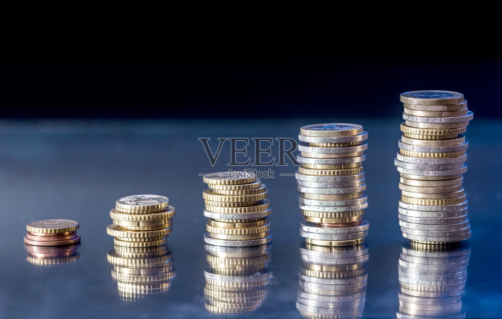 欧元硬币作为业务图孤立在蓝黑色的背景照片摄影图片