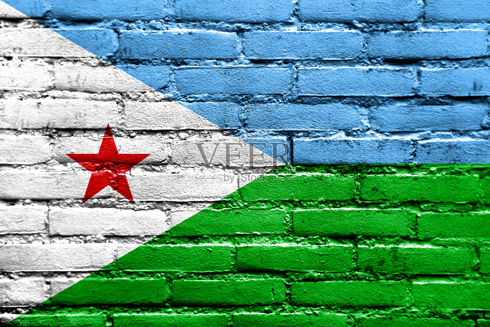 砖墙上画着吉布提国旗照片摄影图片