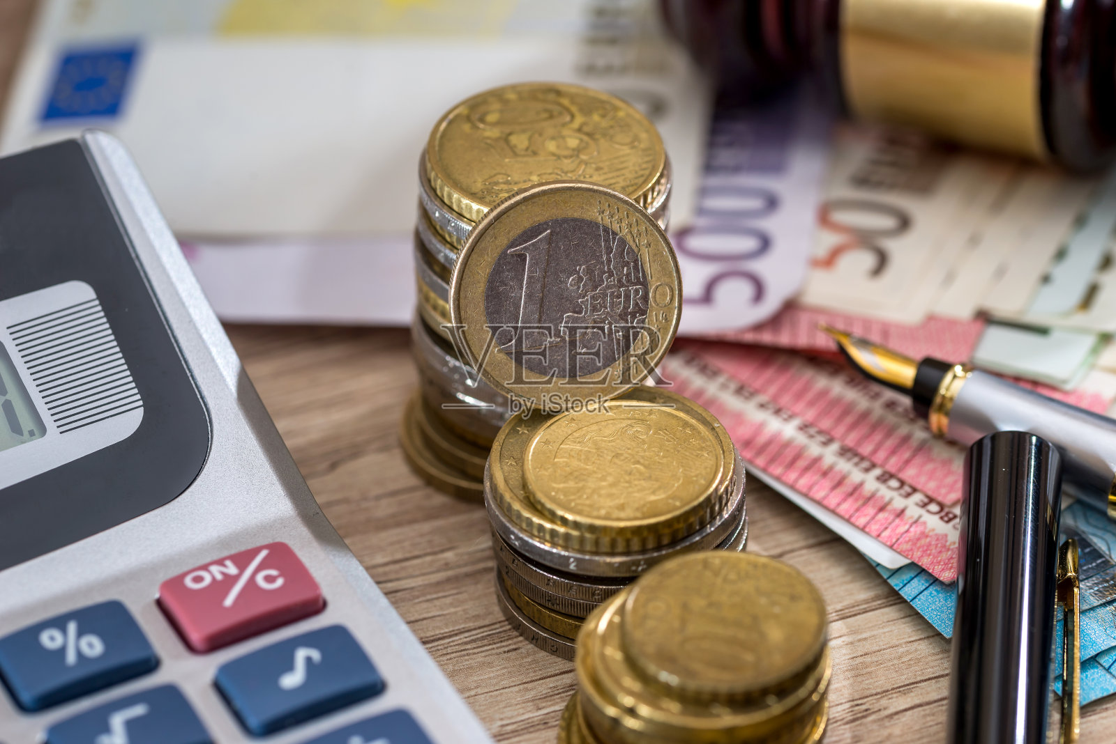 木制锤子、欧元纸币、欧元硬币、计算器照片摄影图片