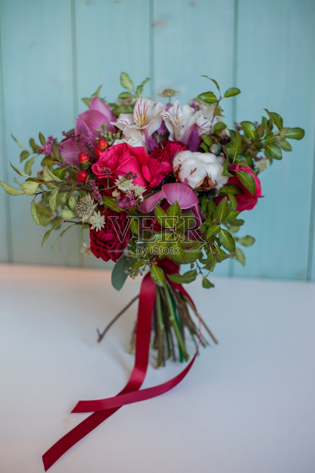 美丽郁郁葱葱的玫瑰花束，绿松石背景，礼物照片摄影图片