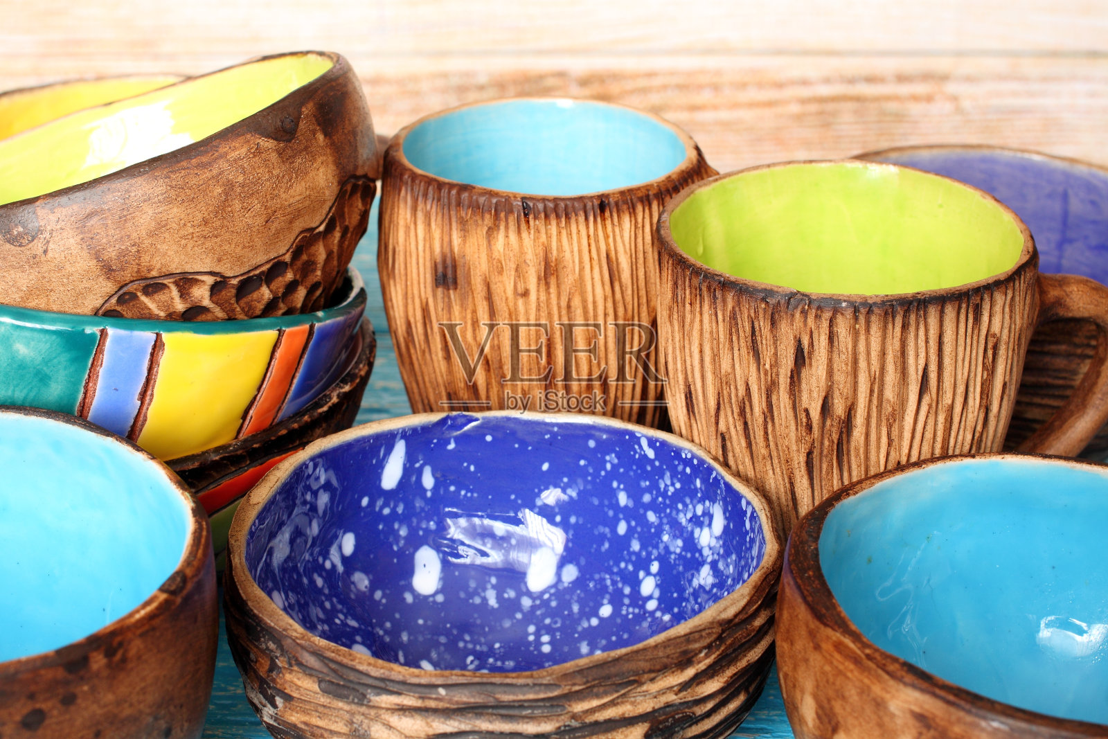 许多不同的鲜艳多彩的陶瓷手工碗和杯子。内部的陶瓷照片摄影图片