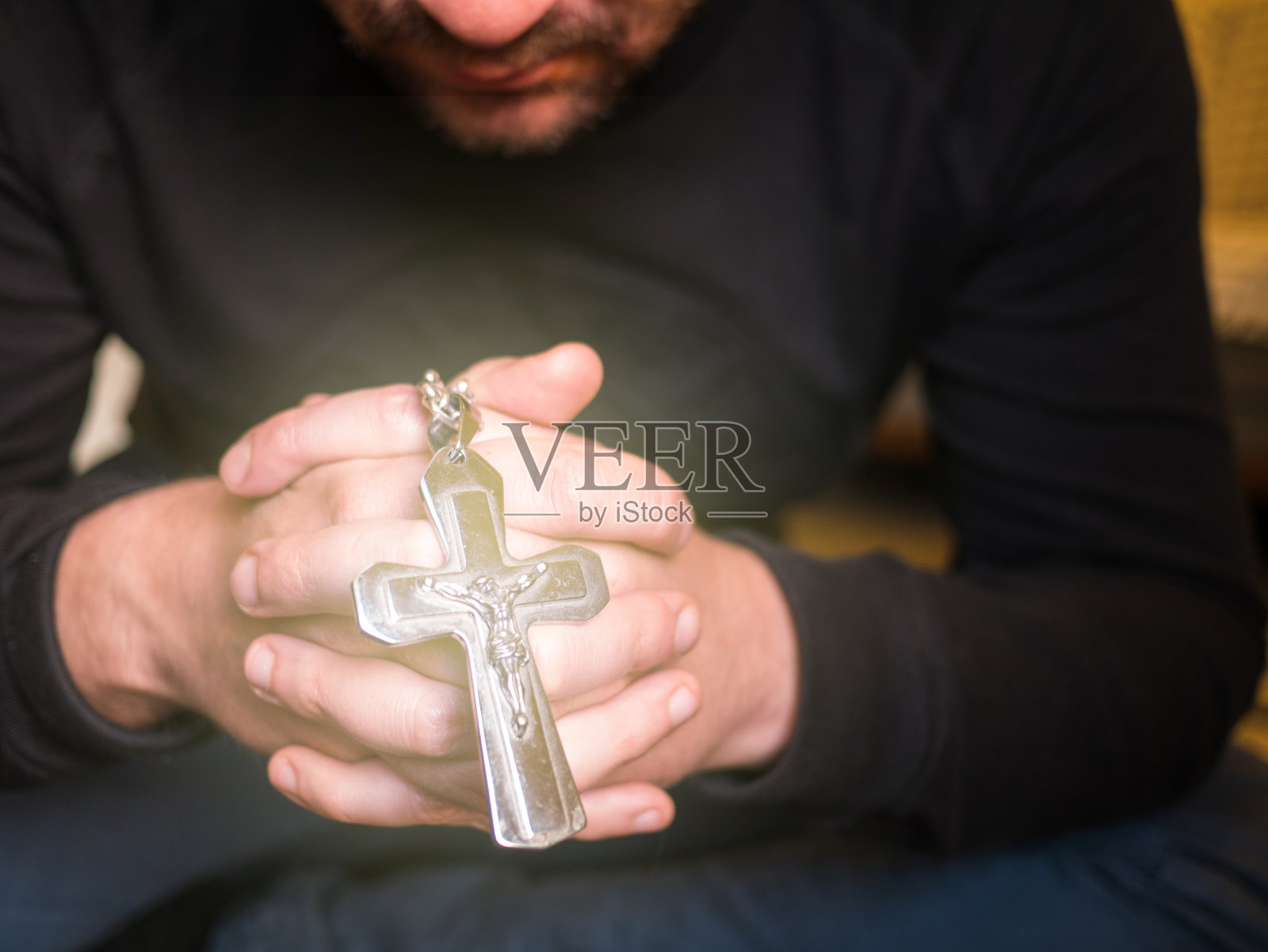 男人祈祷和拿着十字架与耶稣，基督教的概念照片摄影图片